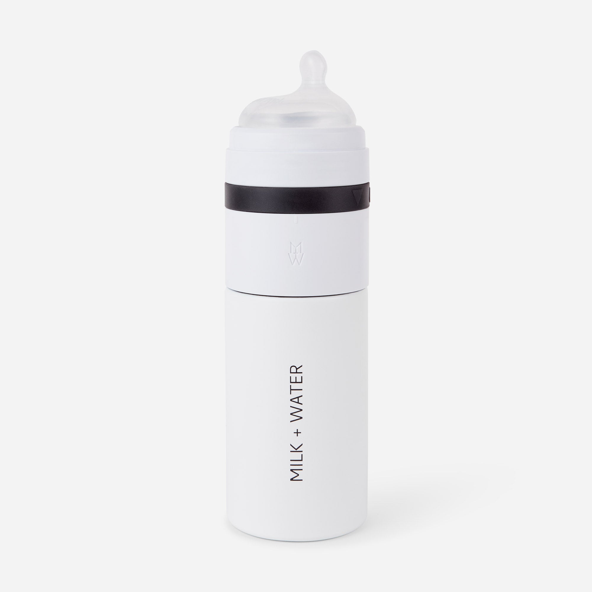 White baby bottle labeled 'MILK + WATER' with a black band and clear nipple.